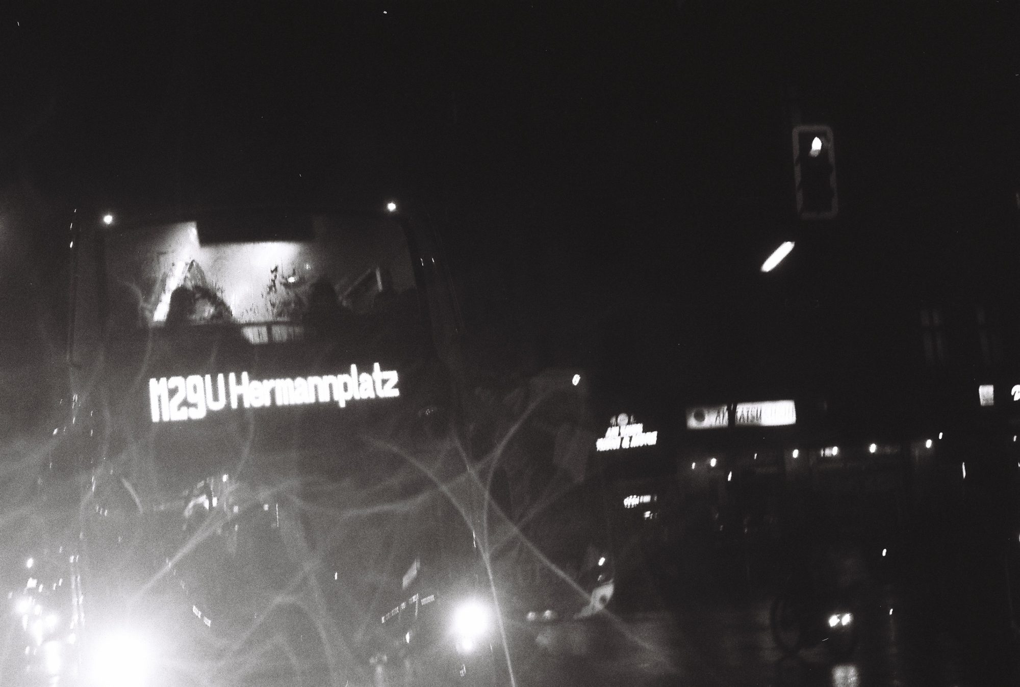 Night bus to U Hermannplatz seen through a scratched window
