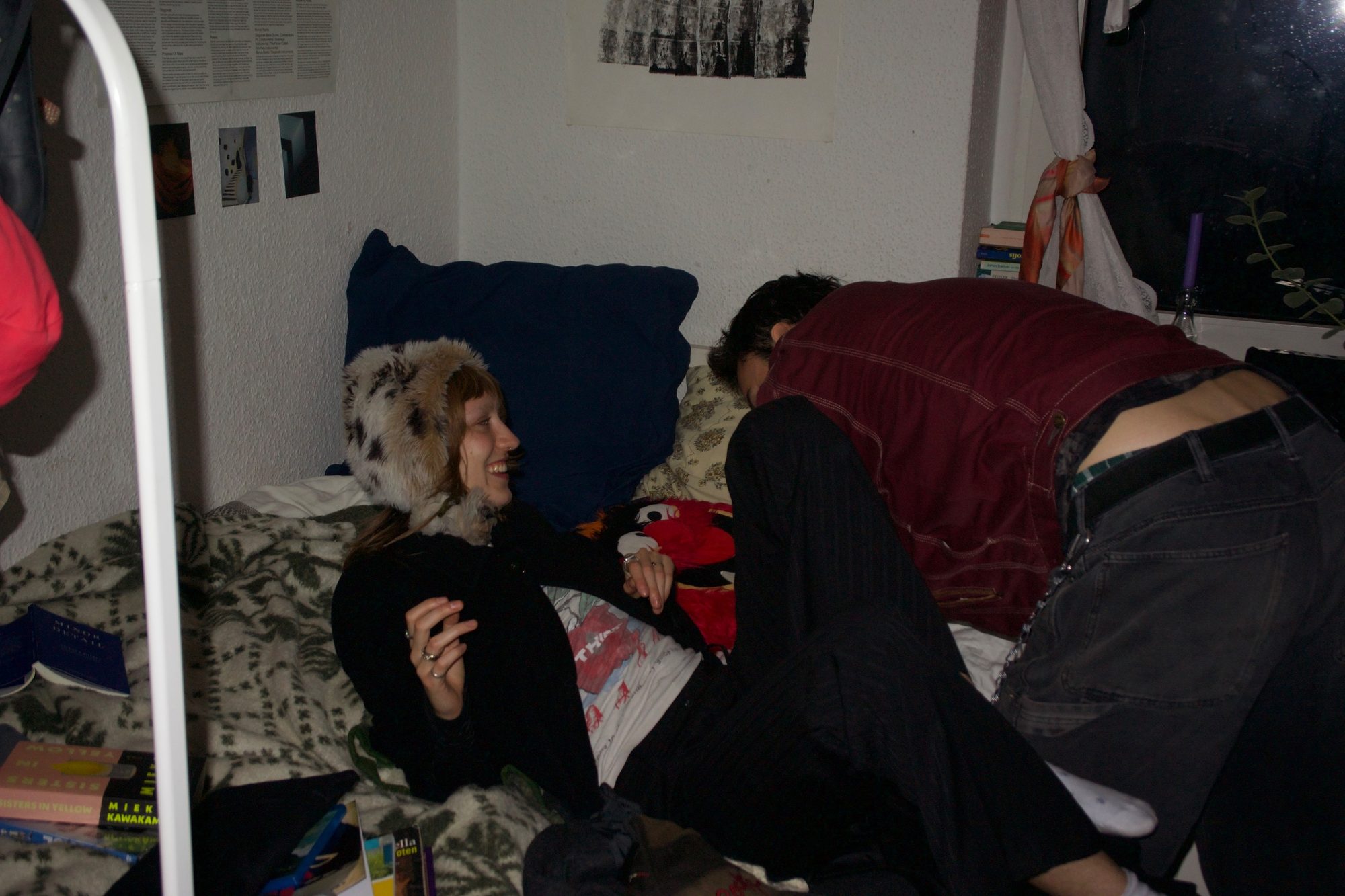 She lies back smiling in a fur hat as he leans over her